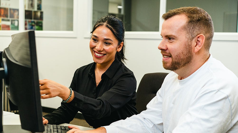 An image of a student in class designing a computer game.
