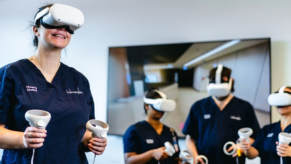 Nursing students use virtual reality headset in classroom.