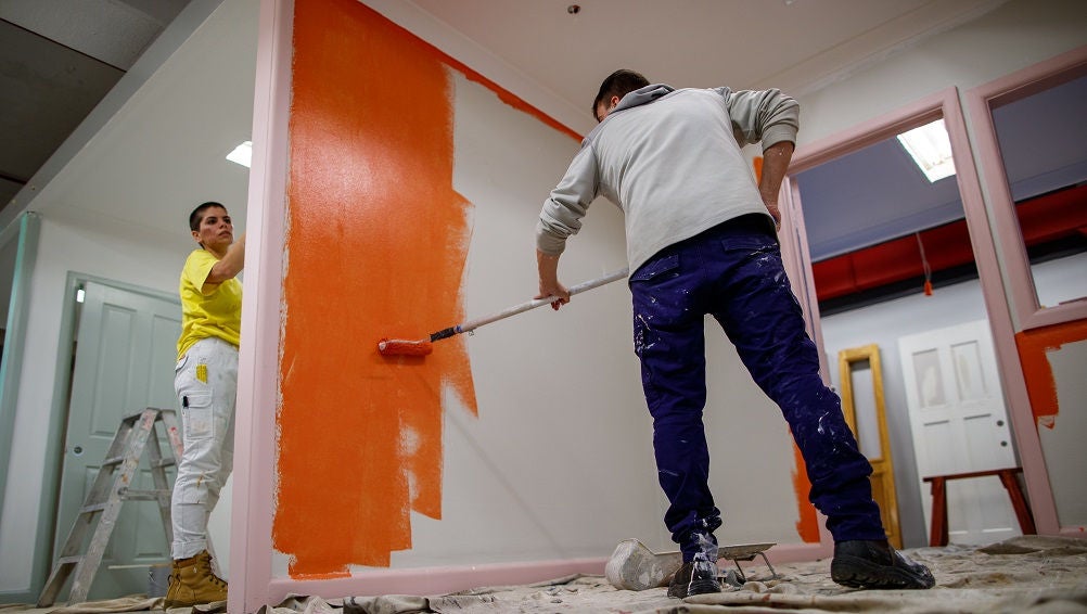 Painting students work on display wall.