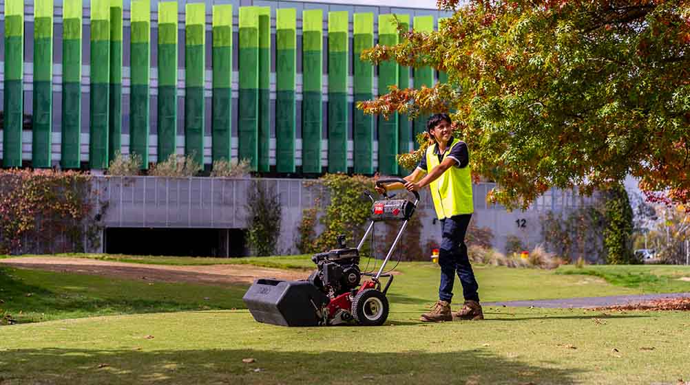 Image of a student cutting the lawn at Holmesglen.