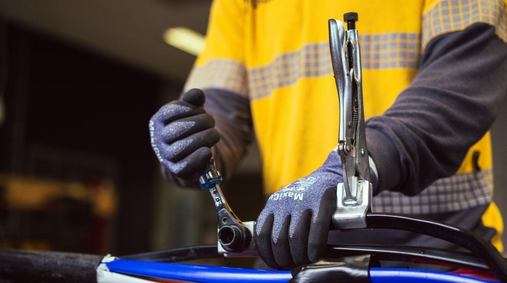 A student connecting electrical cables at the training facility as part of their hands-on training.