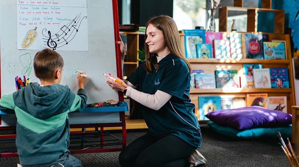 Image of a child with a Holmesglen student in the childcare facility at Holmesglen.