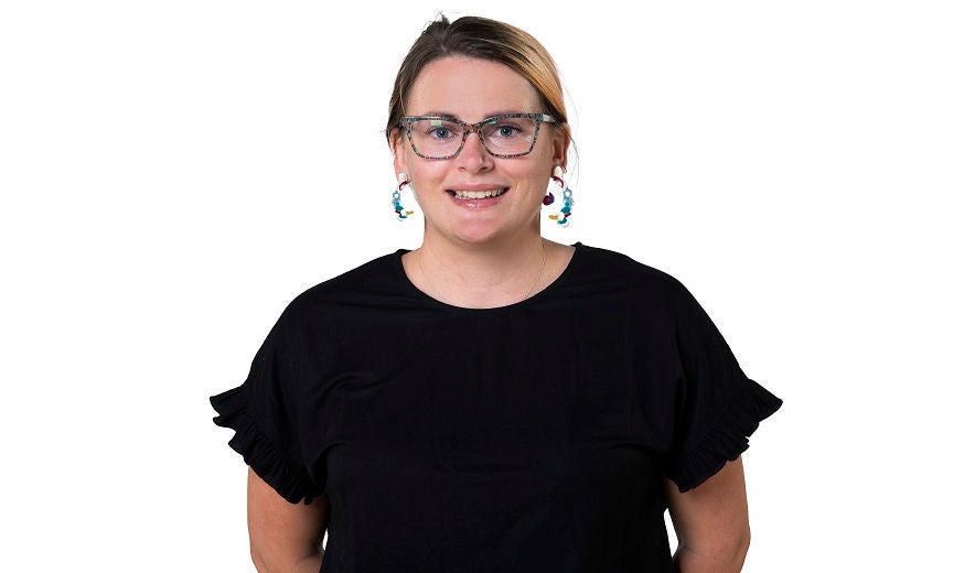 Female student smiles for the camera in photography studio.