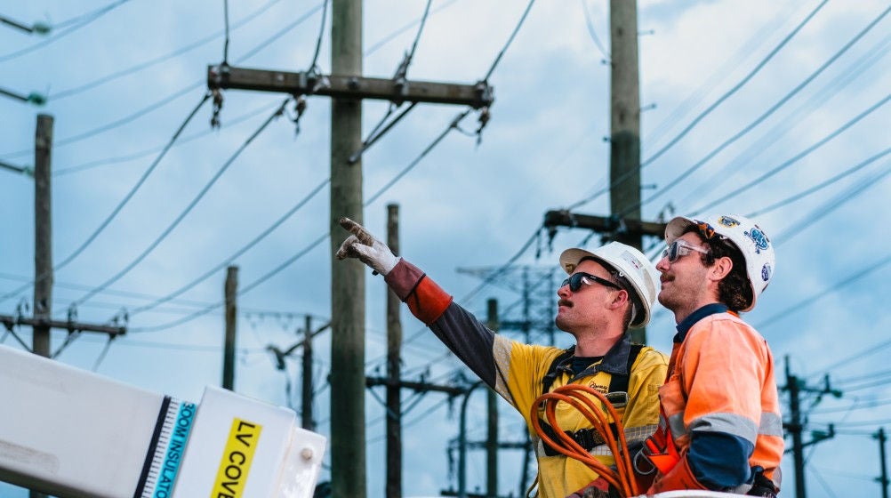 A  trainer demonstrating crane operations to a student