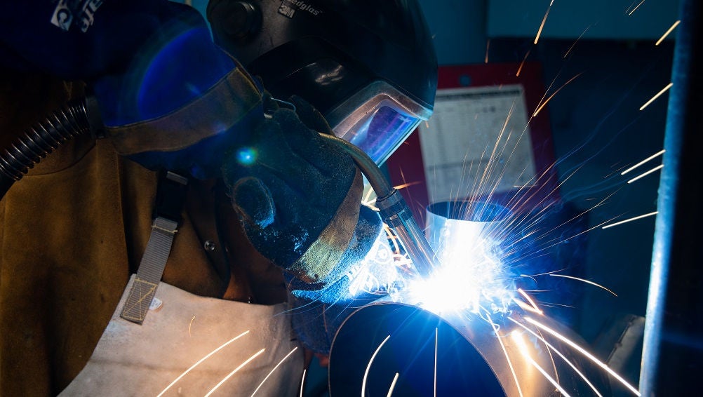 Engineering student undertakes welding.