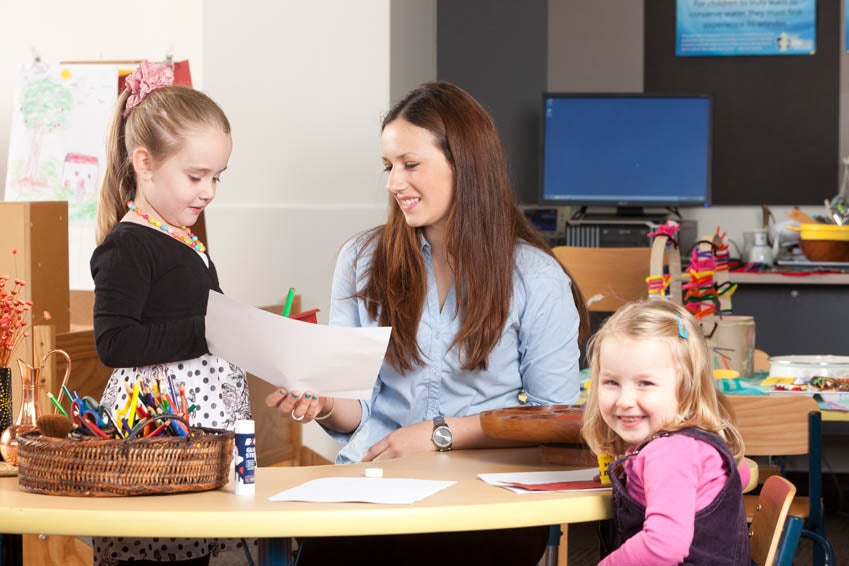 Image of a female teacher with two children in the childcare facility at Holmesglen.