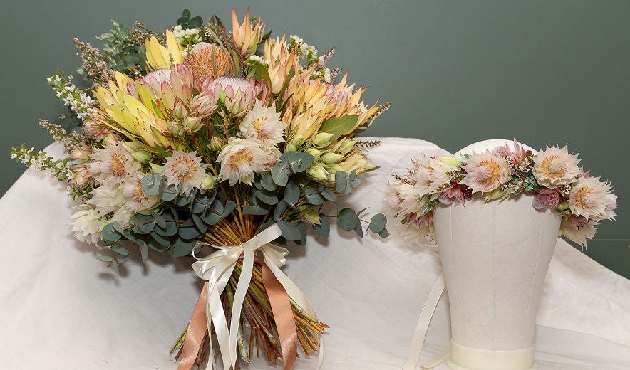 Floristry arrangement sits on table.