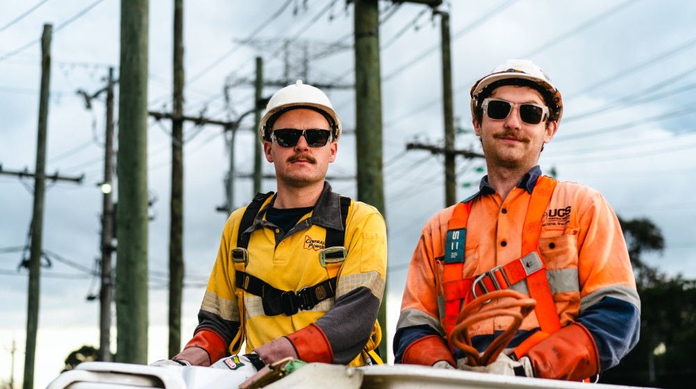 An instructor and a student standing on a crane during a safety training session
