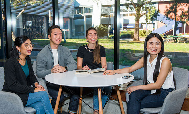 4 students sitting at a round table, talking about their experience studying at Holmesglen