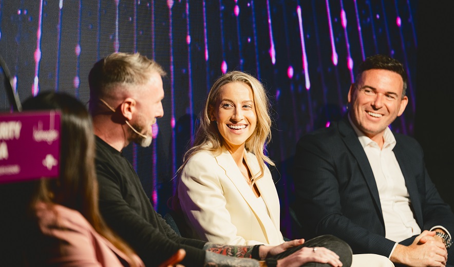 Four panellists sit on a stage and discuss cyber security.