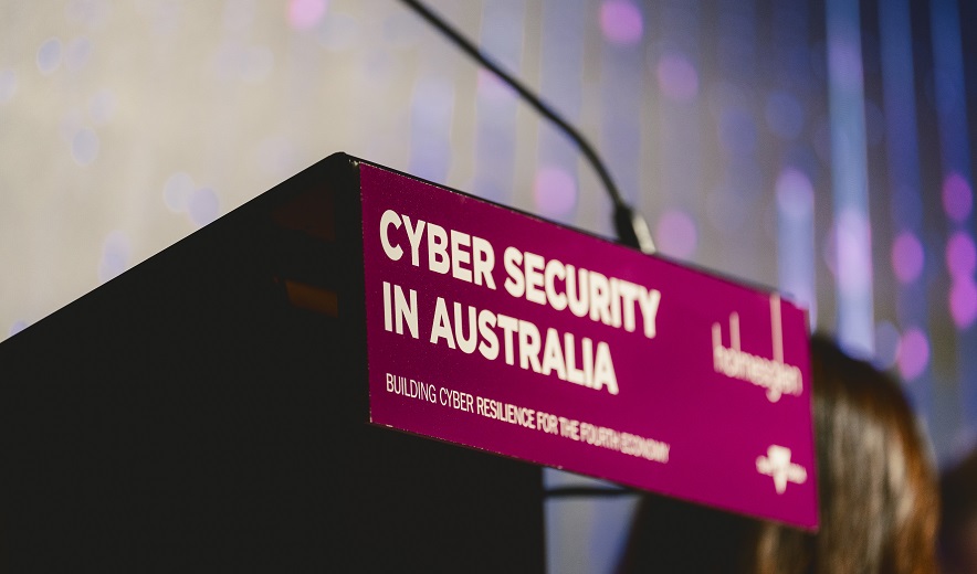 Podium, which features purple Holmesglen cyber security signage.