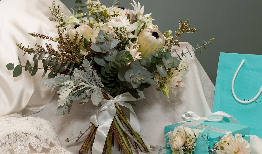 Floral arrangement sits on table.