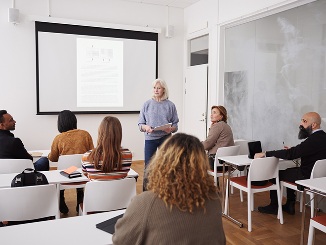 Woman giving presentation at seminar