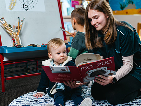 Children enjoy a story read by an educator at the Holmesglen Childcare facility.