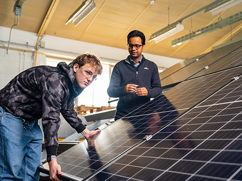 A student is installing a solar panel at Moorabbin under the teacher’s instruction